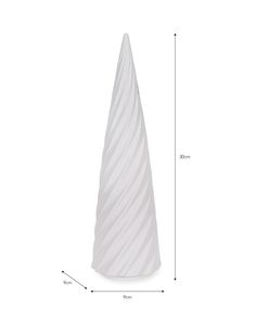 a tall white vase sitting on top of a table next to a ruler and measuring tape