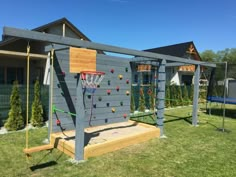 a backyard with a basketball hoop and climbing wall