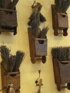 four wooden boxes with plants in them hanging on the wall