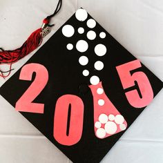 a black graduation cap with white dots and red writing on it that says, 2013