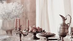 a table topped with lots of silverware and candles