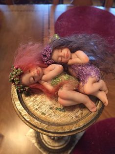 two dolls are laying on top of each other