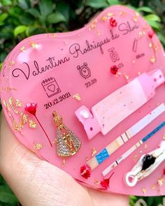 a pink heart shaped box with various items inside