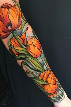 an arm tattoo with orange flowers on it