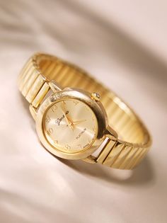 A versatile wristwatch featuring a circular face with a stretchable strap for comfortable wear and timeless style. It effortlessly complements any outfit while ensuring a snug fit on your wrist. Wide Width Boots, Women's Watches, Dainty Necklace, Boot Shop, Elegant Woman, Statement Earrings, Watch Bands, Timeless Style, Snug Fit