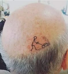 a man with a tattoo on his head has a small stick figure drawn on the back of his head