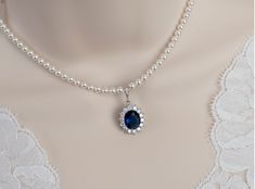 Blue Sapphire Necklace, Bridal Necklace, Bridal Pearl and Blue Sapphire Oval Drop  Necklace, Something Blue Necklace, Wedding Bridal Jewelry Materials: - 10x14mm Blue Sapphire cubic zirconia teardrop pendant - white Swarovski pearls - Rhodium Plated over brass clasp The necklace comes with a 1 1/2 inch rhodium plated over brass extension chain. The listing is for one necklace.  ❤❤ ❤BRIDAL and BULK ORDERS DISCOUNT ❤ ❤❤  5% Discount : 2 items (Use Coupon Code - 5DISCOFF) 10% Discount : 3-5 items (Use Coupon Code - 10DISCOFF) 15% Discount : 6 items and more (Use Coupon Code - 15DISCOFF) Here is a helpful link how to use the coupon code discount: www.etsy.com/help/article/350 The necklace will arrive packaged ready for gift giving in a delicate white jewelry box with a silver ribbon. All metal Blue Safire Necklace, Pearl Sapphire Necklace, Pearl And Sapphire Necklace, Blue Oval Pendant Necklace For Wedding, Oval Sapphire Necklace For Wedding, Sapphire Oval Pendant Necklace For Weddings, Sapphire Necklace Wedding, Royal Blue Jewelry, Blue Gem Necklace