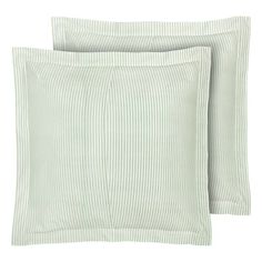 two green and white striped pillows on top of each other