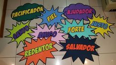 several colorful speech bubbles are on the floor in front of a wall with spanish words