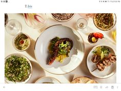 a table topped with plates and bowls filled with food