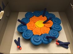 a blue and orange cake in a box