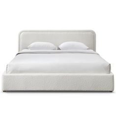 a white bed with two pillows on top of the headboard and night stands next to it