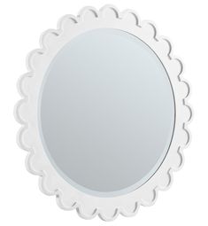 a white round mirror with scalloped edges