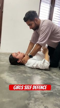 a man helping a woman with her head on the floor while she is being assisted by an adult