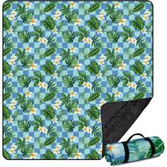 a blue and green blanket with white flowers on it