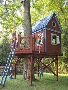 children playing in a tree house with ladders and climbing bars on the top floor