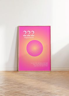 a pink poster with the number 22 on it sitting in front of a white wall