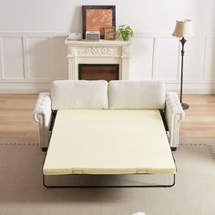 a white couch sitting on top of a wooden floor