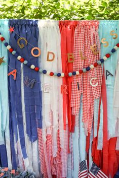 an assortment of colorful ribbons hanging from a clothes line