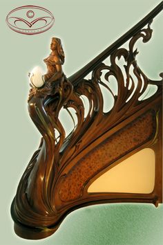 an ornate wooden clock with a woman on it's face and light shining in the center