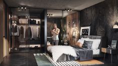 a woman standing in front of a closet with clothes on hangers and a bed