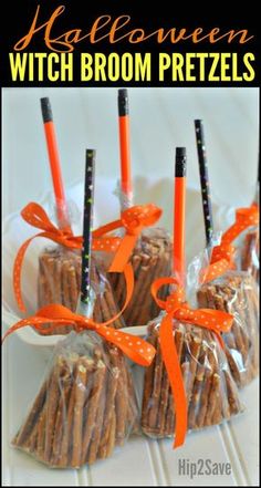 halloween witch broom brown pretzels on a white plate with orange ribbon and candy sticks