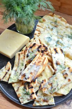 a plate topped with cheese and crackers on top of a wooden table