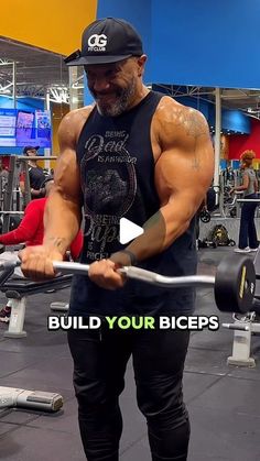 a man in black shirt lifting a barbell with words above it that says build your biceps