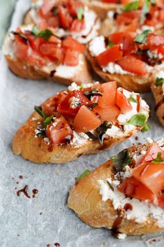 several pieces of bread topped with tomatoes and cheese