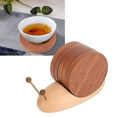 a wooden spoon rest next to a bowl of tea