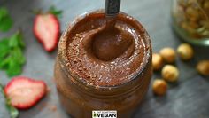 a chocolate smoothie in a jar with strawberries on the side