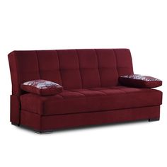 a red couch with two pillows sitting on it's back legs and arm rest