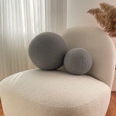 two balls sitting on top of a white chair