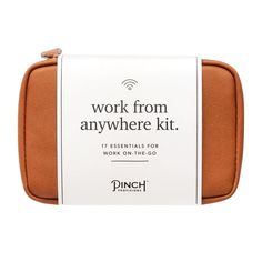 the work from anywhere kit in tan leather with white and black lettering on it's side