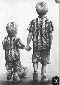 two little boys holding hands while standing next to each other