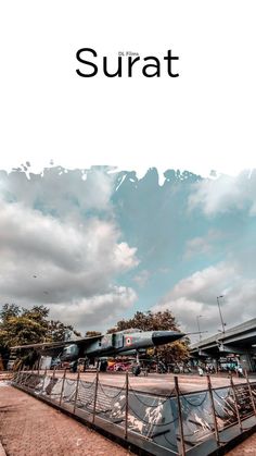 an image of the sky and clouds over some trains on display at a train station