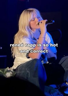 a woman sitting in front of a microphone on top of a stage with the words rene rapp is so hot and correct