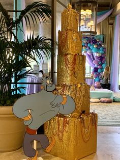 an elephant is standing next to a gold christmas tree in the lobby at disney's animal kingdom