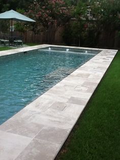 an empty swimming pool in the middle of a yard