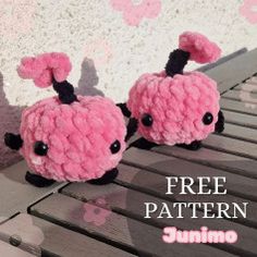 two pink stuffed animals sitting on top of a wooden bench with the words free pattern