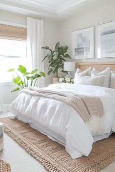 a bed with white linens and pillows in a bedroom next to a large window