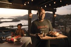 a man holding a tray with food on it