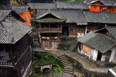 an aerial view of some buildings with stairs leading up to the roof tops and windows