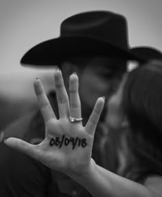 a man and woman are kissing while holding their hands in the air with words written on them