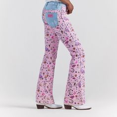 The Wrangler X Barbie Retro High Rise Trouser Jean Takes Pattern Play To A More Adventurous Place. Featuring An All-Over Pattern Of Western Riding Icons, Playful Details, And Plenty Of Pink, This Pair Offers Contrasting Pockets, A 10-Inch High Rise, And A Contoured Waist. It's A Reinterpreted Classic With Limitless Potential, Like The Women Who Wear Them. Fit: Regular Rise: High Front Rise: 10 1/4" Leg: Trouser Leg Opening: 21 3/4" Front Closure: Zipper And Button Mid-rise Bottoms For Fall Rodeo, Casual Mid-rise Festival Jeans, Casual Mid-rise Jeans For Festival, Casual Mid-rise Bottoms For Festival, Casual Jeans For Rodeo, Western Style Straight Leg Jeans For Spring, Western Style Fitted Jeans For Spring, Spring Western Fitted Jeans, Western Style Mid-rise Jeans For Spring