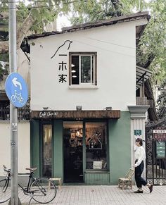 a man walking past a store front with bicycles parked outside