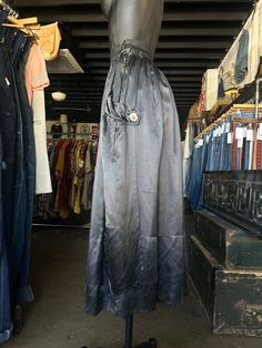 Antique Silk Charcoal Black Full Length Skirt. Charcoal gray/black in color. Brand is unknown. Skirt is made from silk fabric. Full length skirt with a flowy fit. Side hook and eye closure with snaps down the side. Super soft with a lightweight feel. Oversized button accents on sides. Condition overall is good/fair with some flaws that include; there are pinholes along front and couple on back of skirt. Small tear at bottom hem. Please see all photos for details.  Refer to measurements below to ensure a proper fit (modeled on a size small mannequin) fits true to size 12.5" across waist (25") 37" in total length Evening Full Skirt With Elastic Waistband, Evening Full Skirt Bottoms With Elastic Waistband, Black Silk Flared Skirt, Silk Full Skirt With Gathered Detail, Silk Lined Long Skirt, Black Silk Pleated Skirt Bottoms, Black Silk Bottoms With Pleated Skirt, Black Full-length Silk Skirt, Black Silk Full-length Skirt