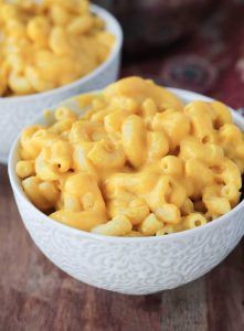 two white bowls filled with macaroni and cheese