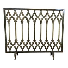 an iron gate with decorative designs on the top and bottom, set against a white background