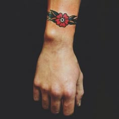 a person with a flower tattoo on their wrist